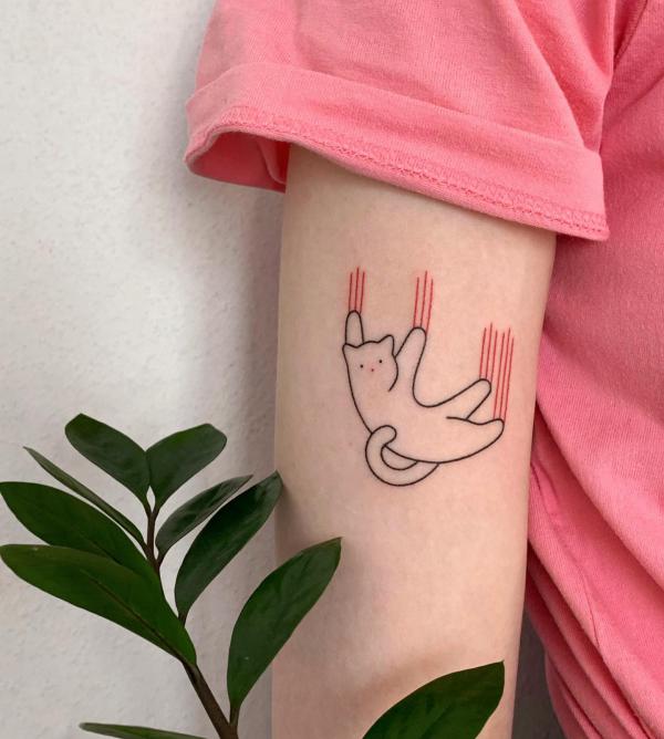 Cat line work upper arm tattoo