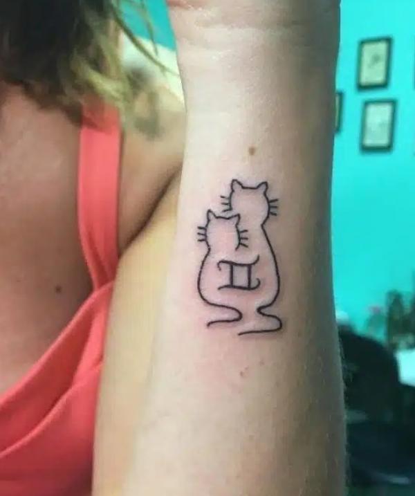 Cat twin with Gemini glyph tattoo