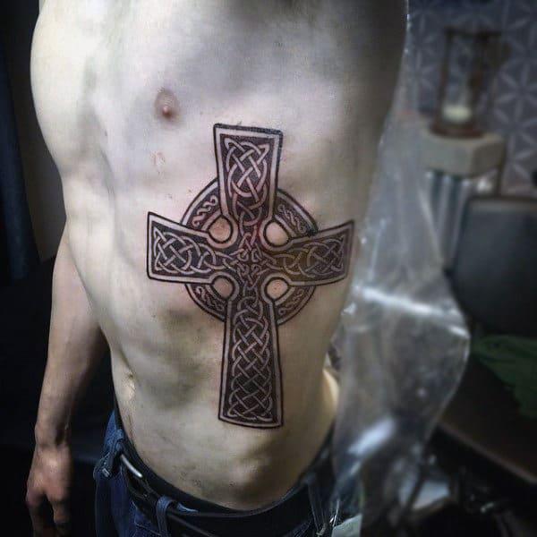 Celtic cross rib cage tattoo