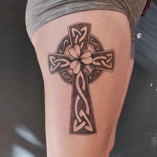 Celtic cross with Trinity Knot and clover thigh tattoo