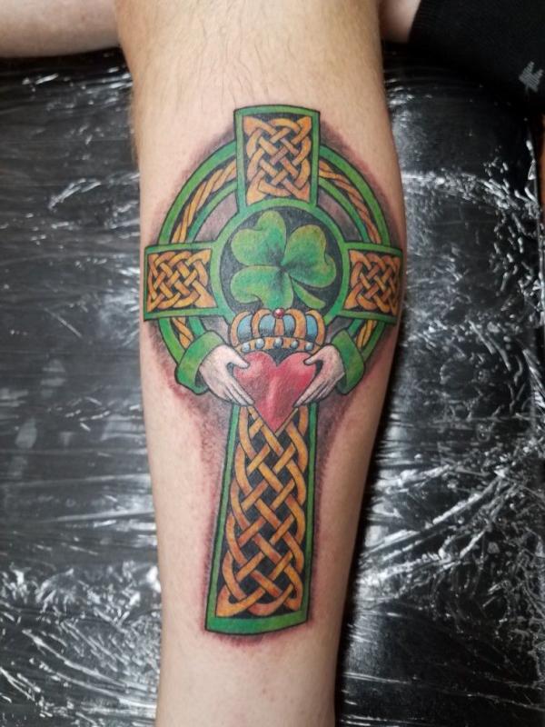 Celtic cross with claddagh and clover lower leg tattoo