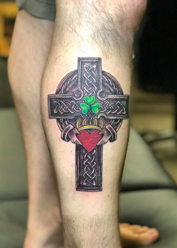 Celtic cross with claddagh and clover tattoo on lower leg