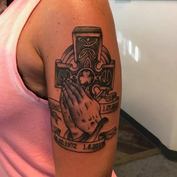 Celtic cross with clover and praying hands tattoo