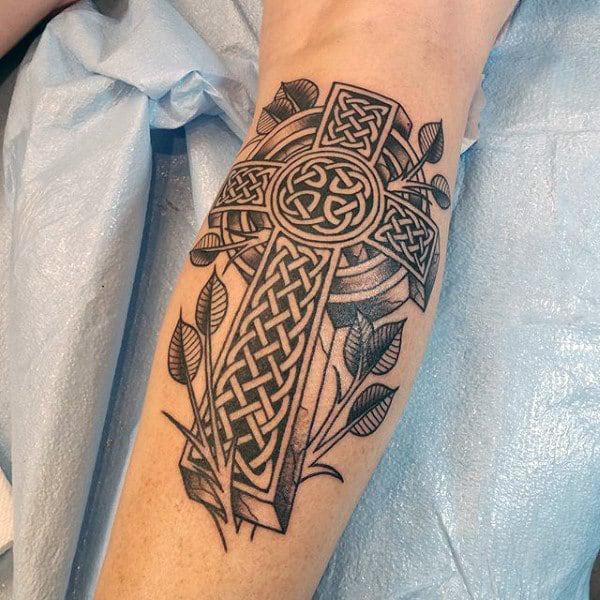 Celtic cross with leaves calf tattoo