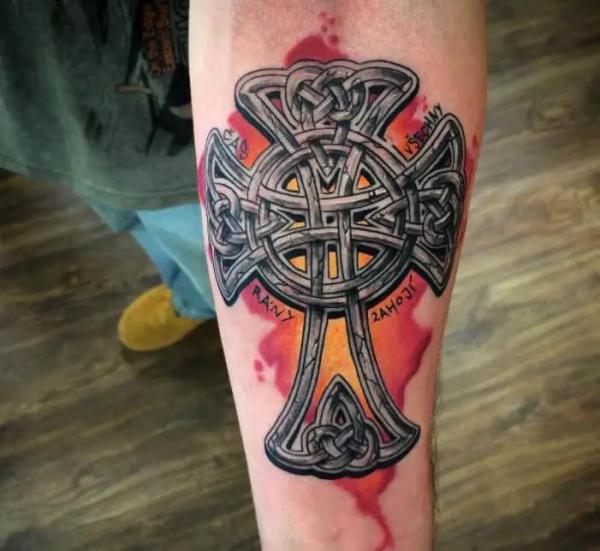 Celtic cross with name on watercolor backdrop tattoo