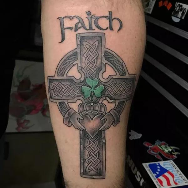 Celtic cross with shamrock tattoo with word Faith