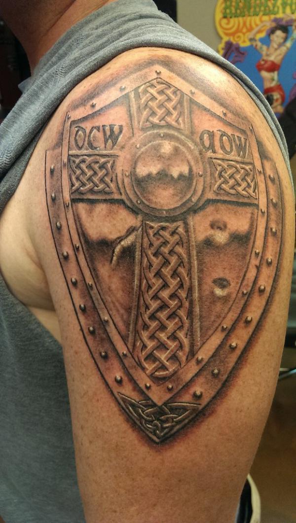 Celtic shield with cross symbol shoulder tattoo