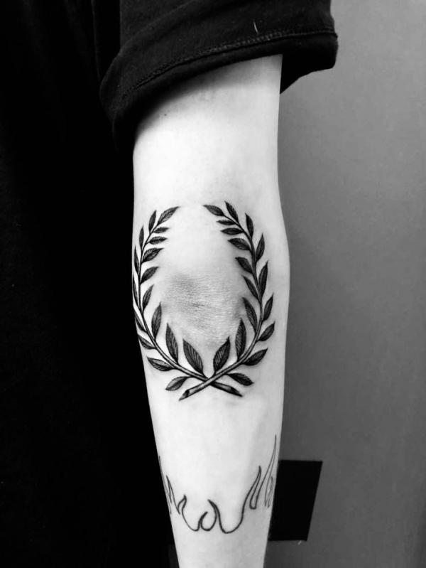 Circular fern elbow tattoo