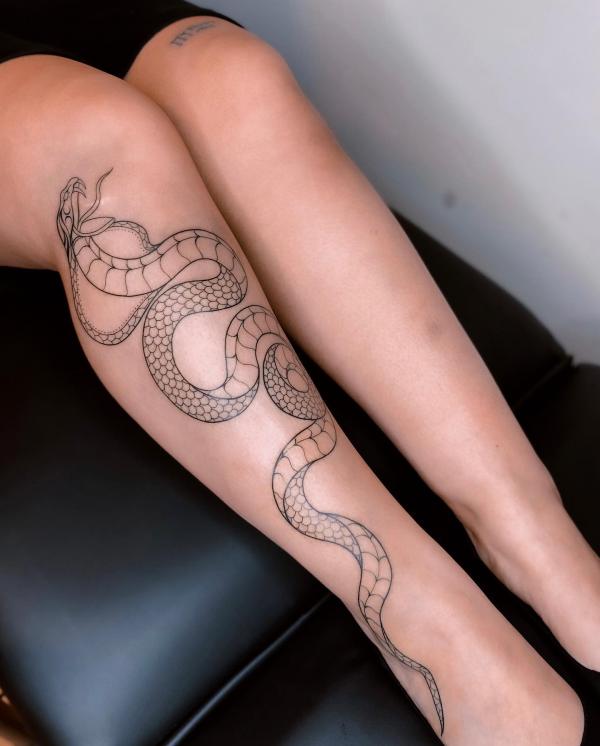 Cobra outline lower leg tattoo