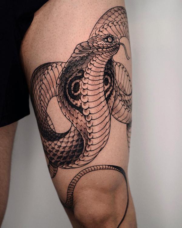 Cobra tattoo above knee tattoo