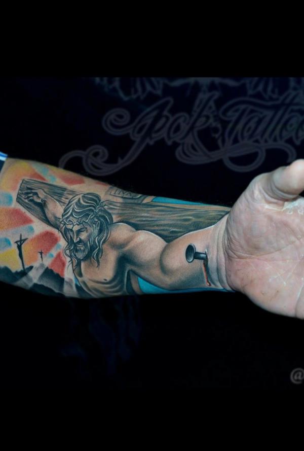 Colored Crucifix forewrm tattoo