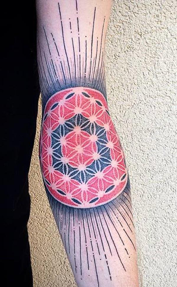 Colored flower of life with rays elbow tattoo