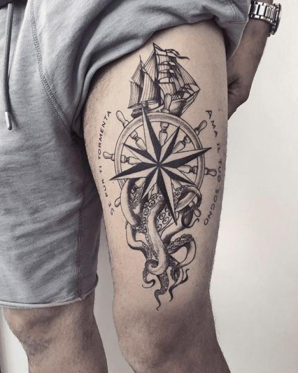Compass wheel with octopus tattoo above knee