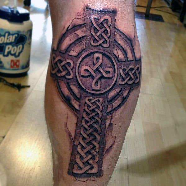 Cracked skin celtic cross calf tattoo