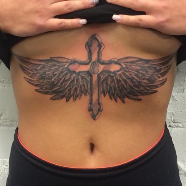 Cross with wings sternum tattoo