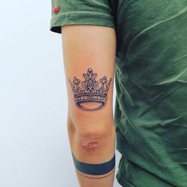 Black and grey crown tattoo done on the inner forearm.