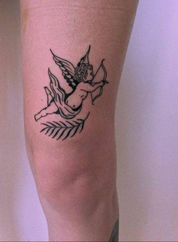 Cute cupid tattoo above knee
