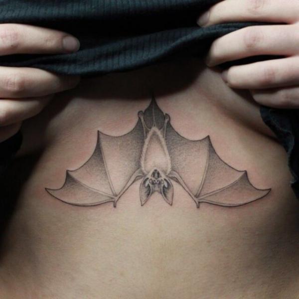 Dainty hanging bat sternum tattoo