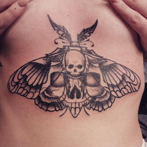 Death moth sternum tattoo