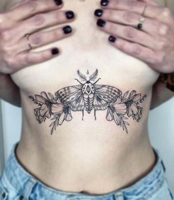 Death moth with flowers sternum tattoo