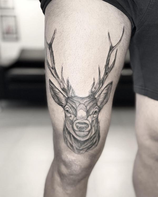 Deer above knee tattoo black and grey
