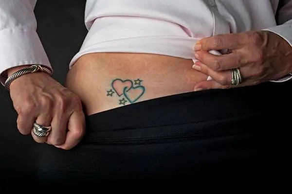 Double hearts with stars bikini line tattoo