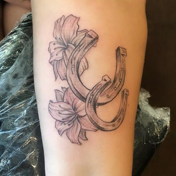 Double horseshoe and lily tattoo