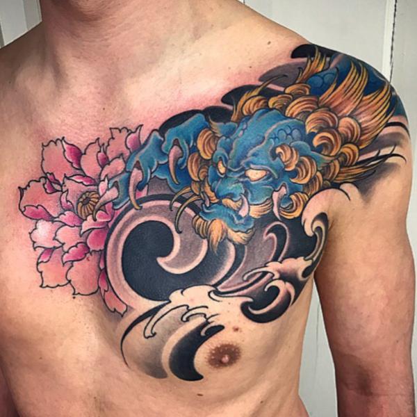 Dragon like foo dog chest tattoo