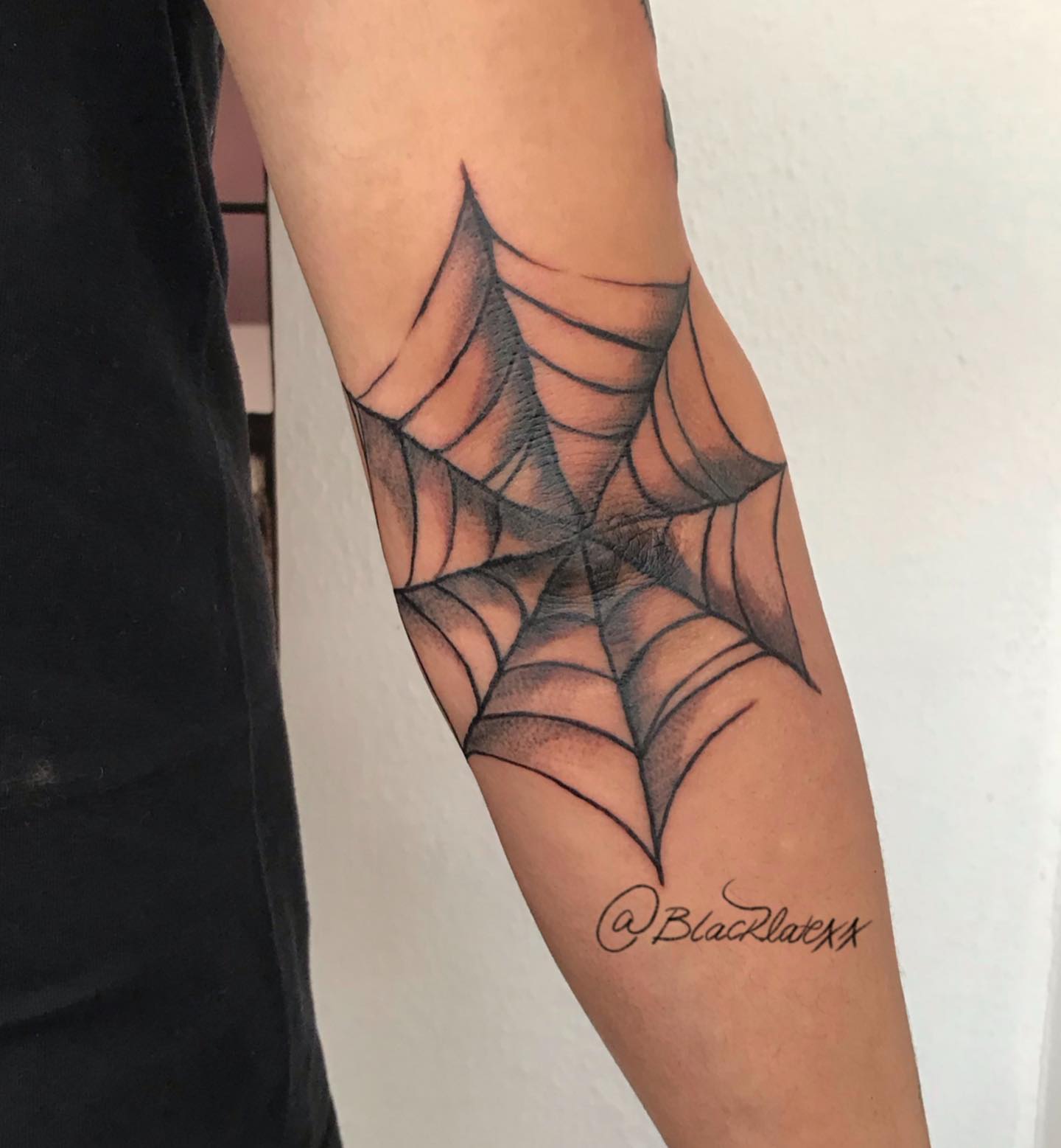 Elbow spiderweb tattoo with black shade
