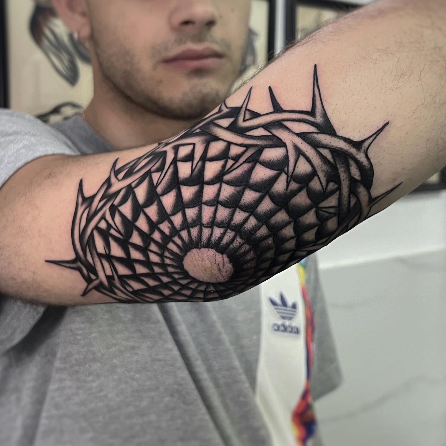 Elbow spiderweb with barbed wire tattoo black and white traditional