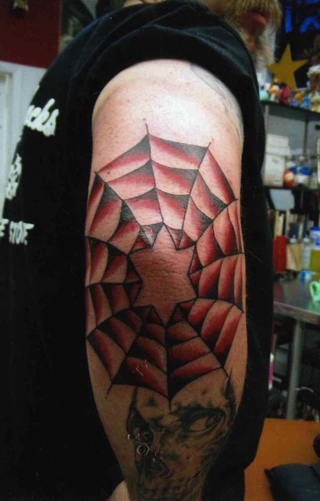 Elbow spiderweb with star tattoo traditional