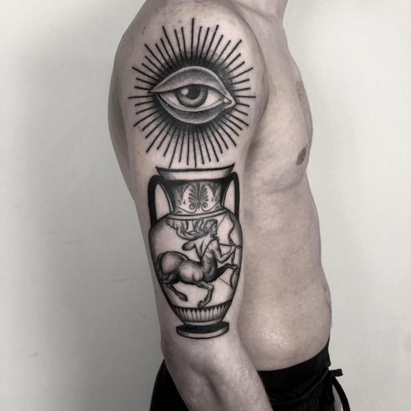 Evil eye and Sagittarius centaur in bottle tattoo