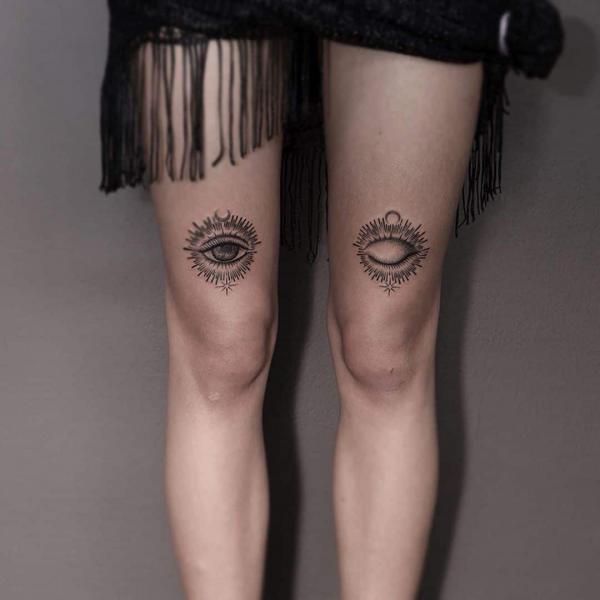 Evil eye with moon and star above knee tattoo