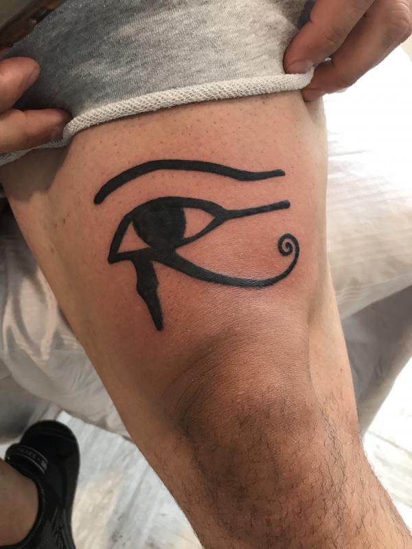 Eye of horus tattoo above knee