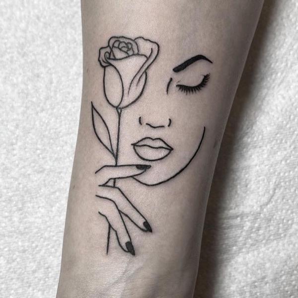 Female face with rose and her fingers outline tattoo