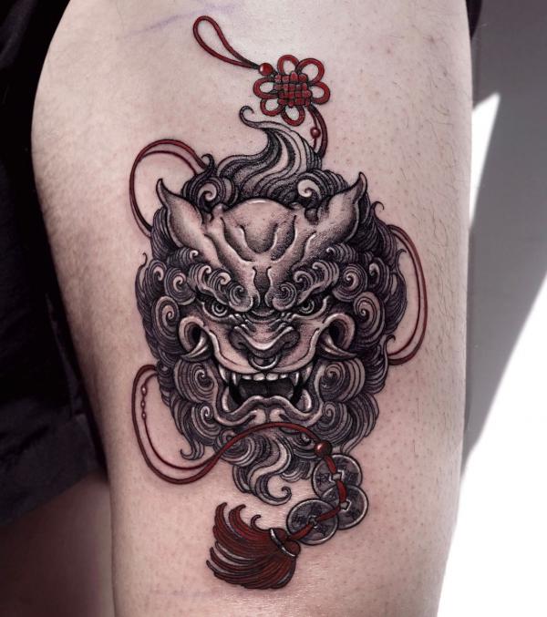 Feminine Foo dog with tassel tattoo