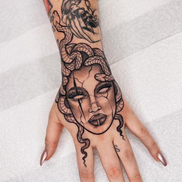 Feminine Medusa hand tattoo