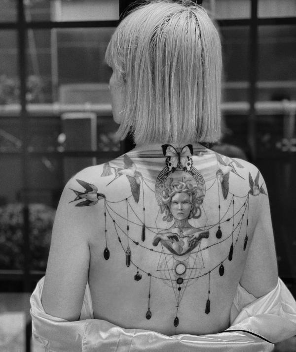 Feminine Medusa with swallow and pendant tattoo