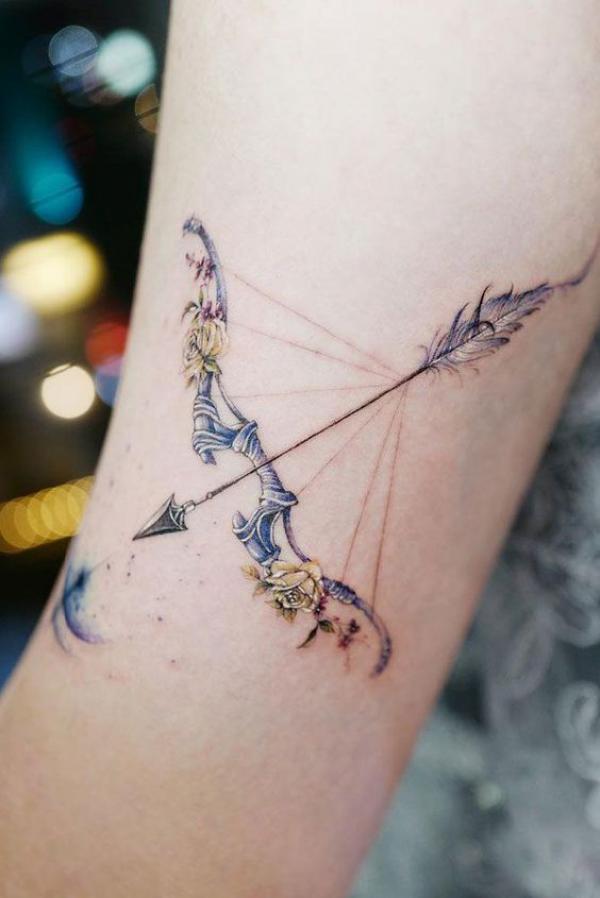 Feminine Sagittarius bow and arrow with yellow roses tattoo