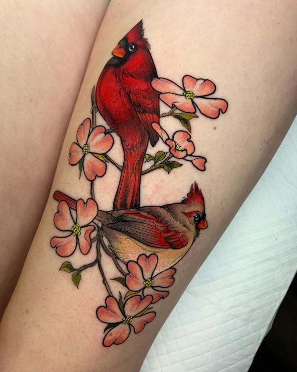 Feminine cardinal with dogwood flower thigh tattoo