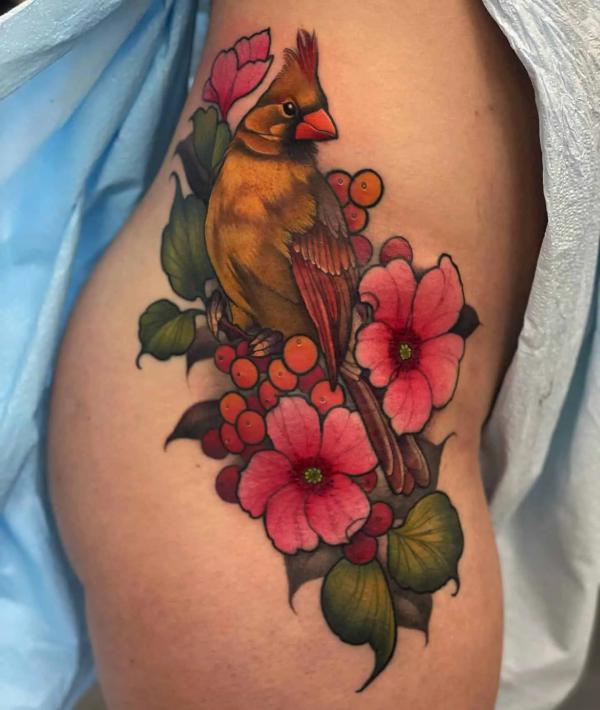 Feminine cardinal with flower tattoo on the side of hip