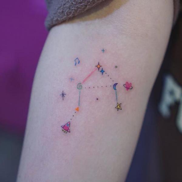 Feminine libra constellation with planet and stars tattoo