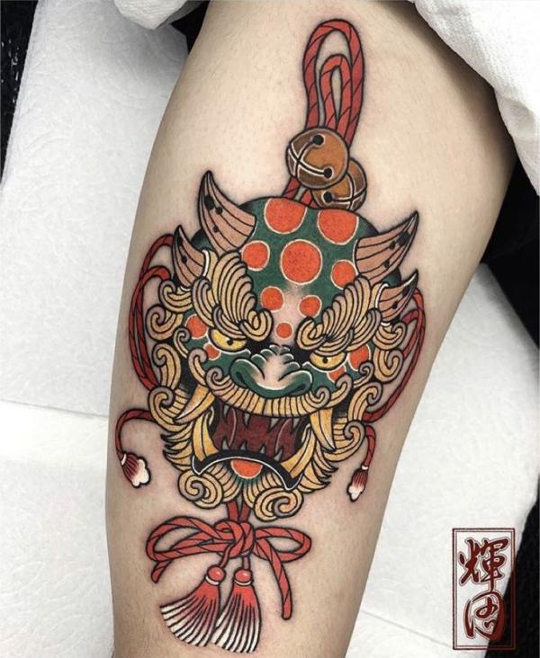 Feminine foo dog tattoo on arm