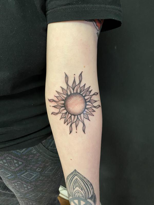 Firing Sun elbow tattoo