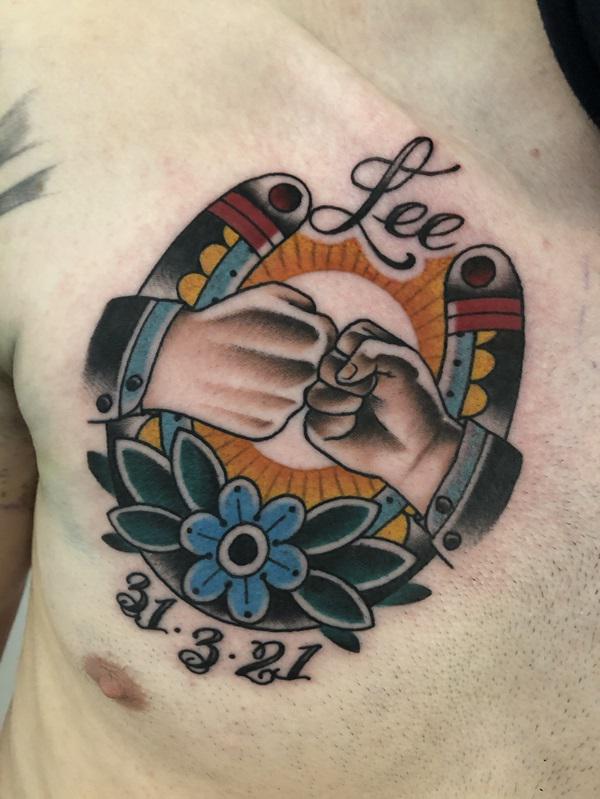 Fist bump and horseshoe with name and date tattoo