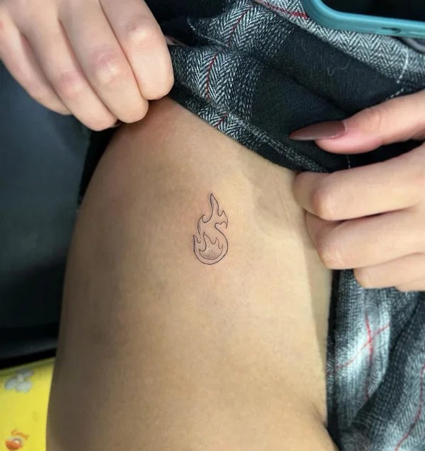 Flame bikini line tattoo