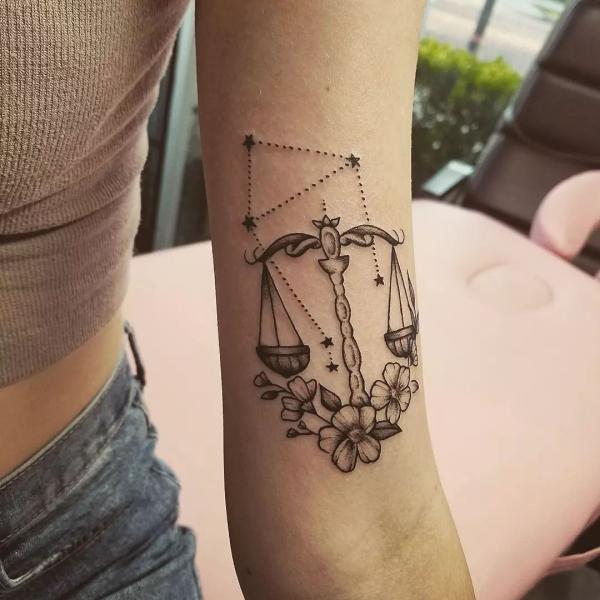 Flower Libra and constellation upper arm tattoo