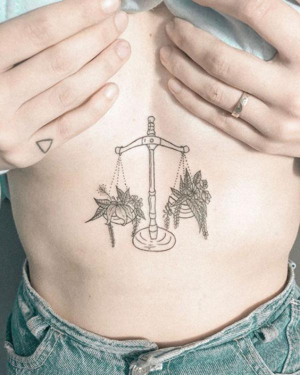 Flower and leaves Libra line work sternum tattoo