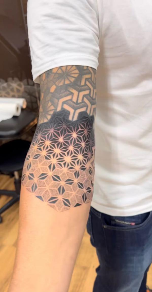 Flower of life geometric elbow tattoo