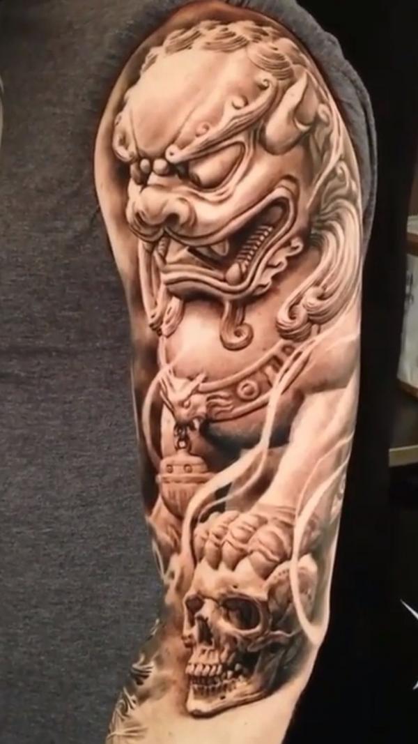 Foo dog and skull half sleeve tattoo